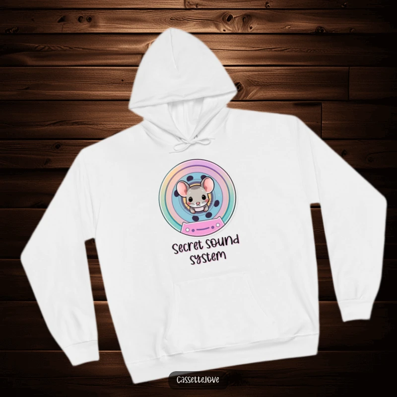 Funny hoodie depicting a tiny mouse emerging from the spool of a colorful, vintage cassette tape, cozy and cute.